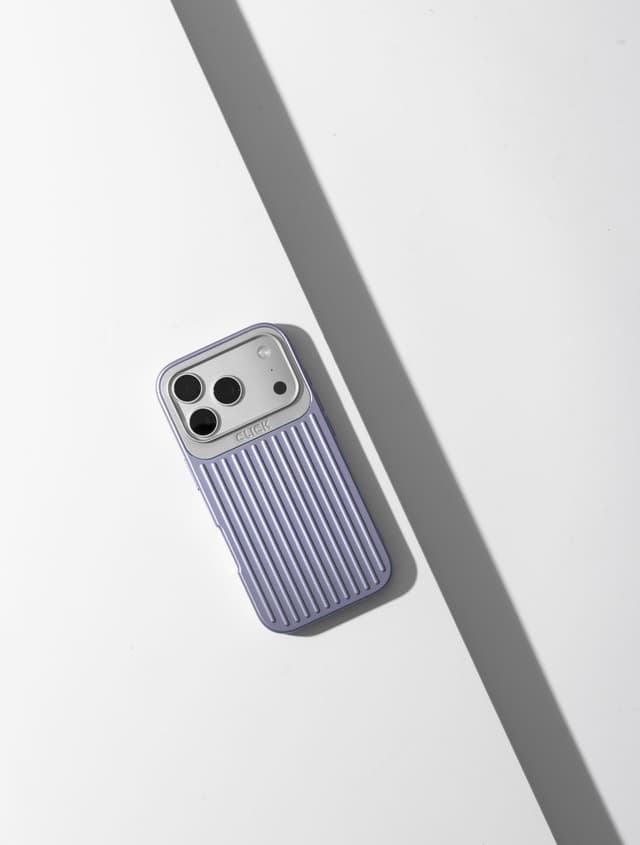 Lilac CLICK Nova case on a phone, leaning on a gray ledge