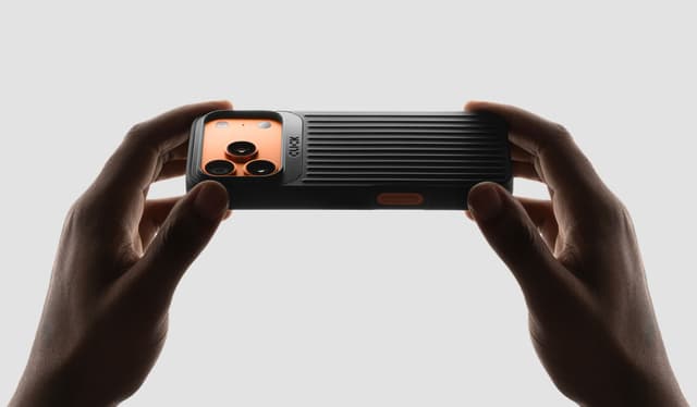 Two hands holding a black CLICK Nova case in landscape, thumbs on the ribbed back