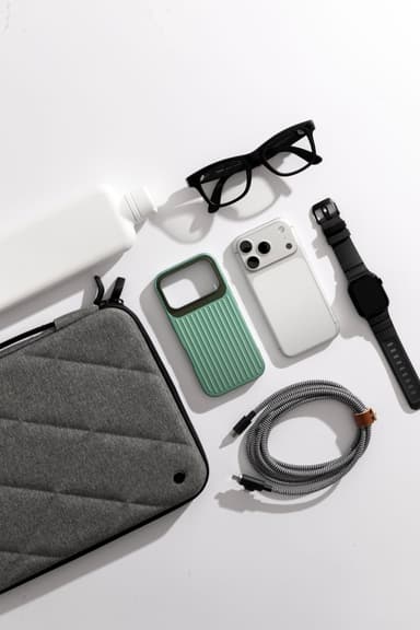A sage green CLICK Nova case lying open beside a bare phone on a pale surface
